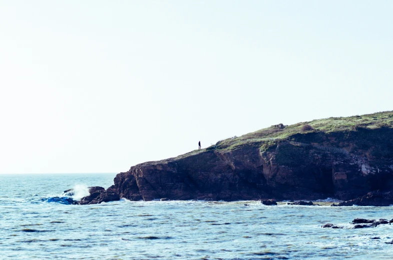 a kite surfer is heading towards a large body of water