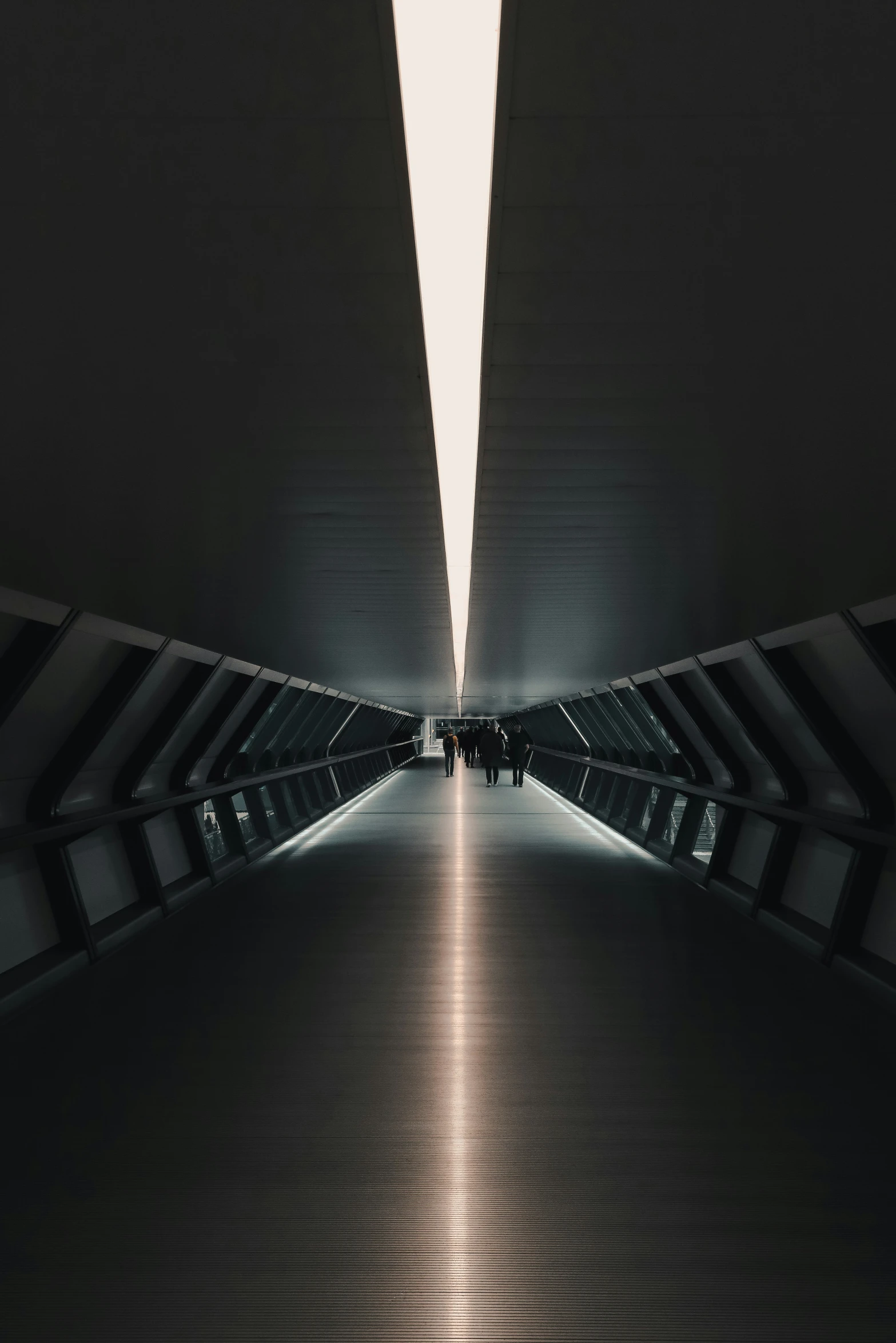 a hallway in a large building with dark walls