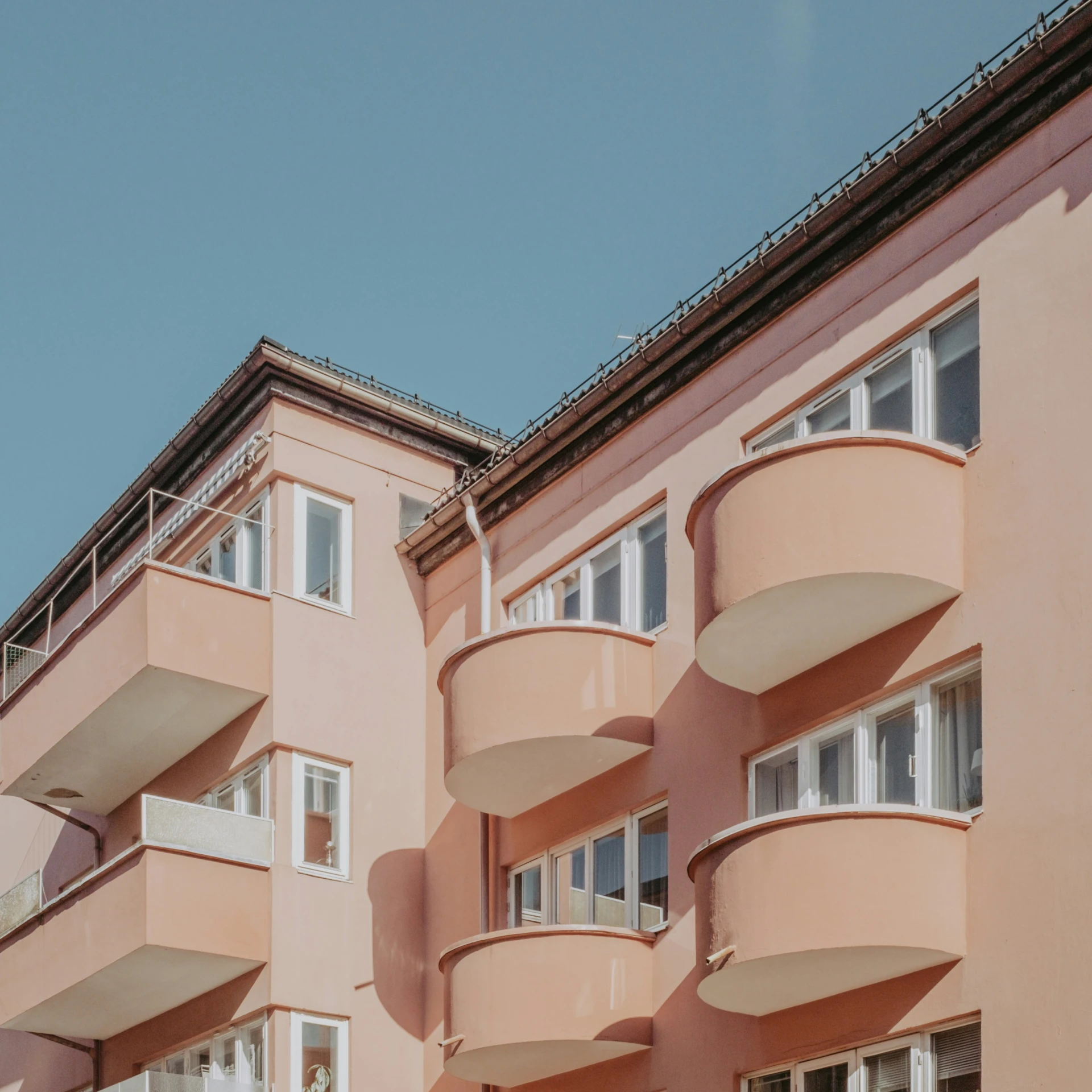 a couple of tall building with balconies on each balcony