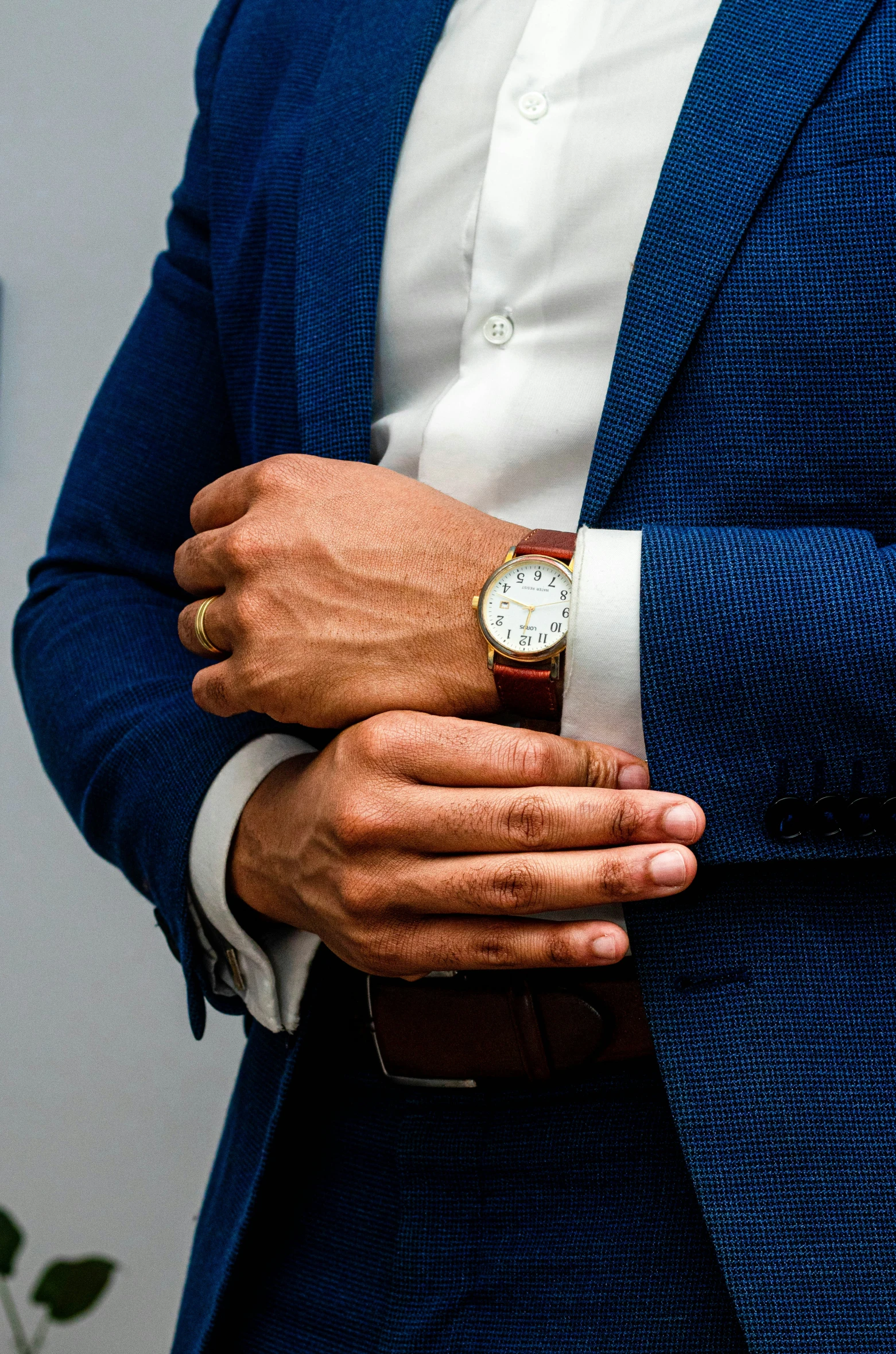 a man wearing a watch and a suit