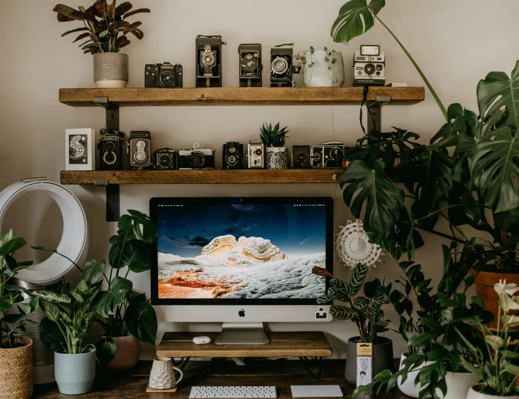 a computer monitor sitting on top of a wooden desk