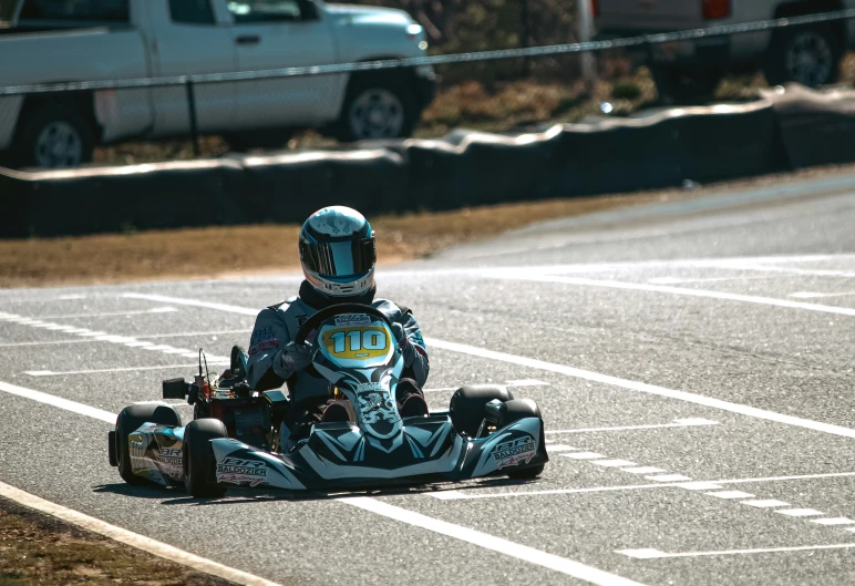 a person riding a go kart at a race