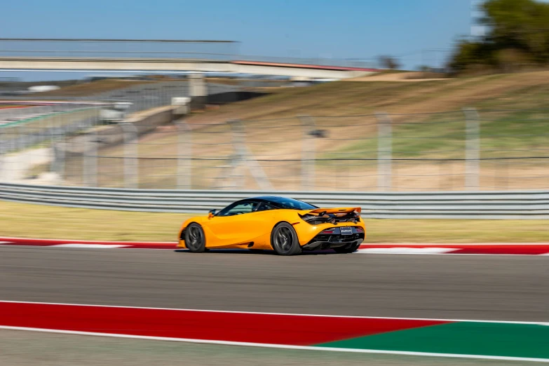 an image of a yellow car speeding on a track