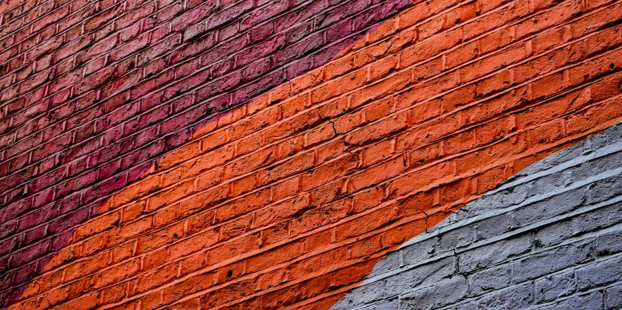 an abstract picture of colored lines on a brick building