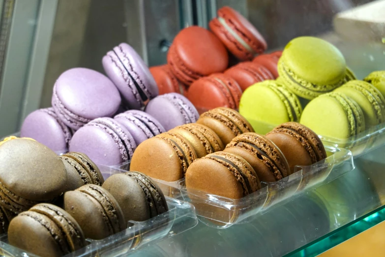 a display case filled with several different color macaroons
