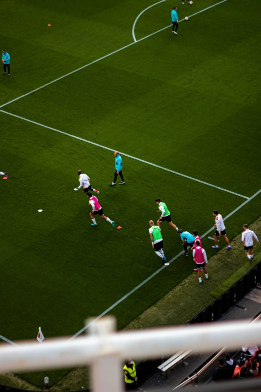 a soccer field full of people playing a game