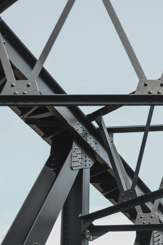 an over cast bridge with lots of different types of metal beams