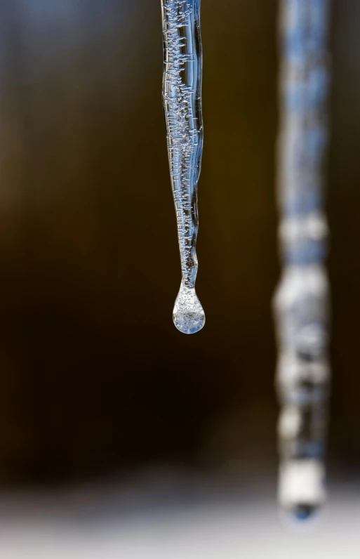 a water drop on the side of an icy pole