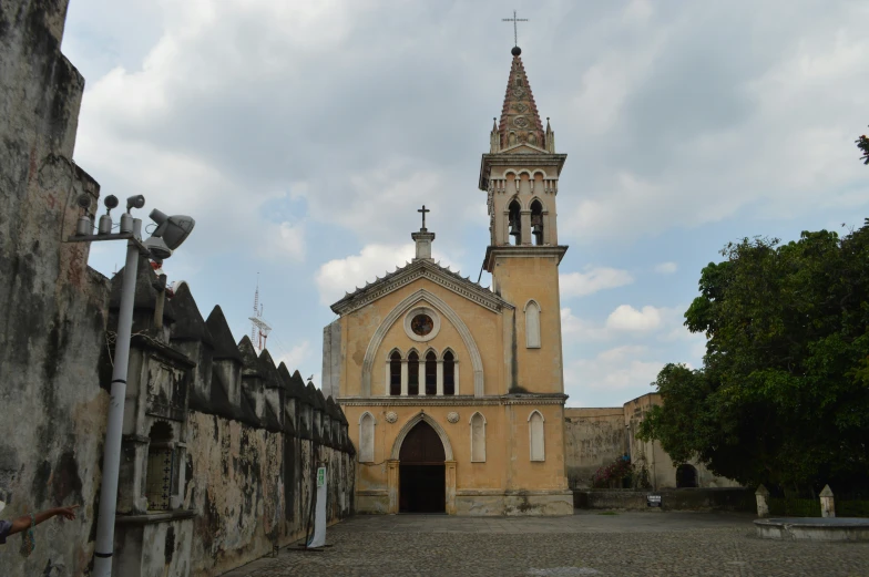 an old church with a steeple in a stone wall