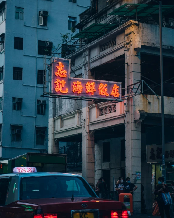 red and yellow street signs are on a pole near cars