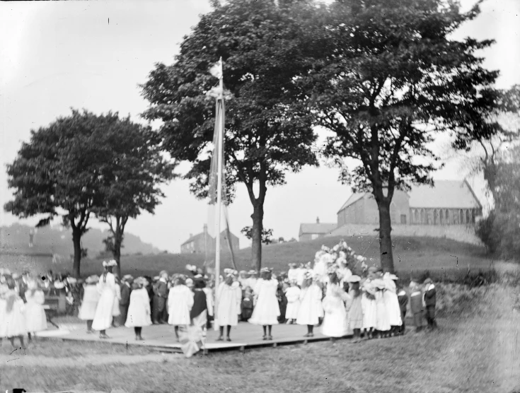 a group of women standing around an american flag pole