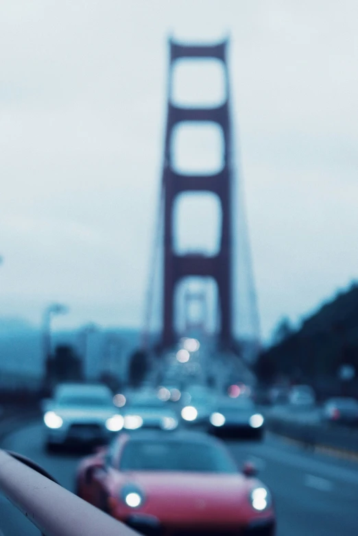 cars drive over the golden gate bridge