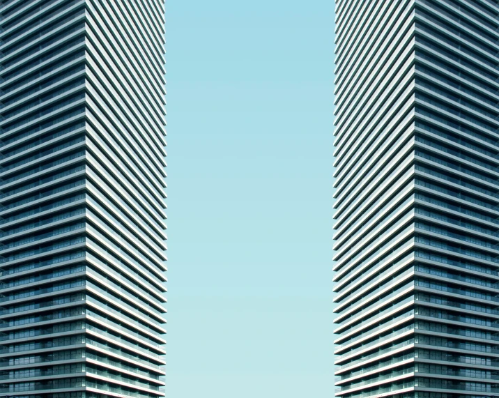 two tall building made of metallic strips on the side