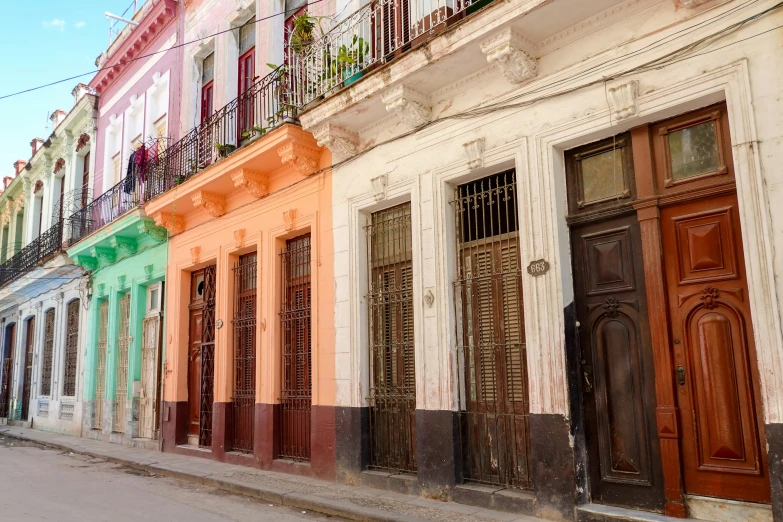 row of different colors buildings and doors on the street