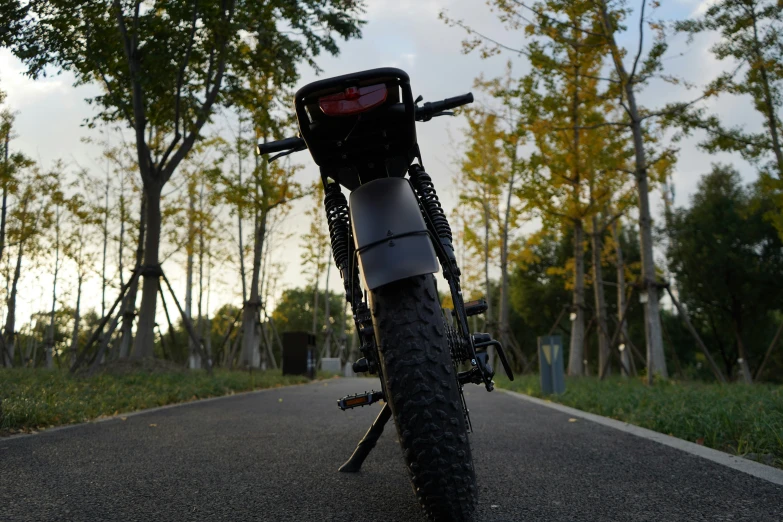 a black and white bike sitting on the road