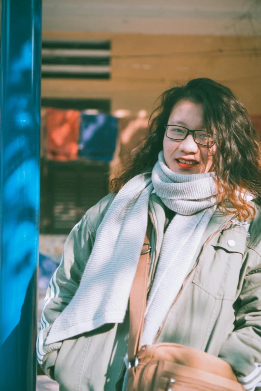 a woman with glasses wearing a white scarf