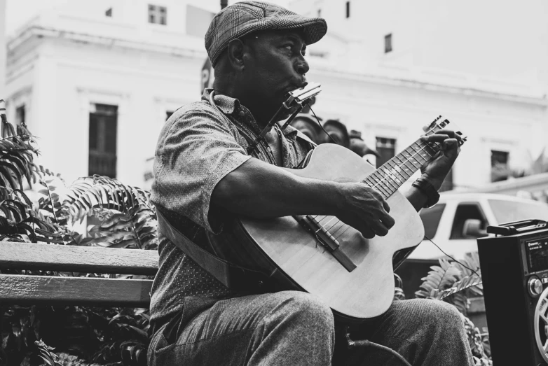 black and white pograph of man playing a guitar