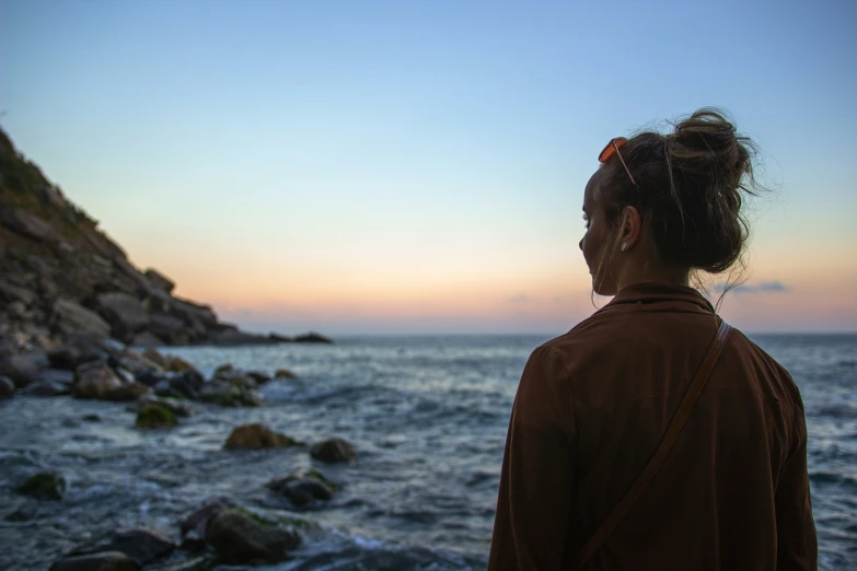 the woman is looking out over the water