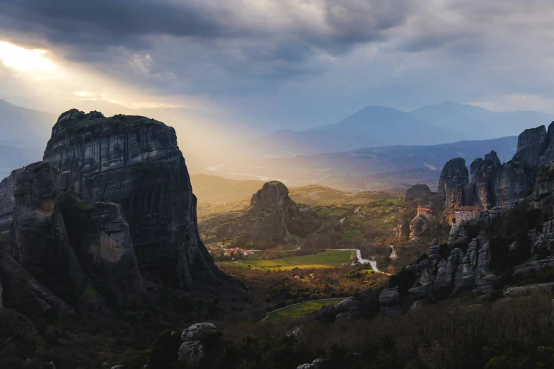 the rock formations in the valley are lit by sunlight rays