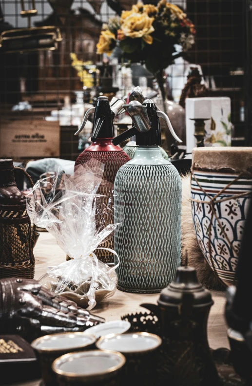 there are many vases on a table together