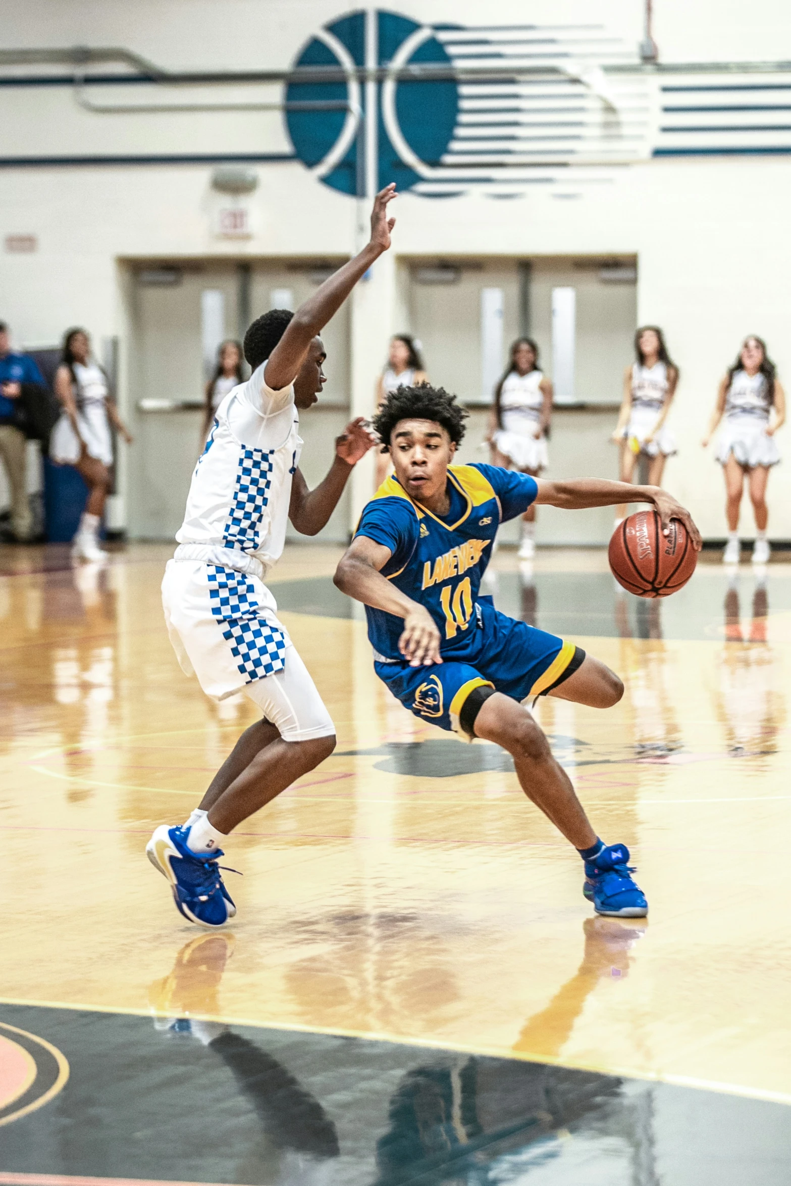 a basketball player is going after the ball as a person tries to steal him