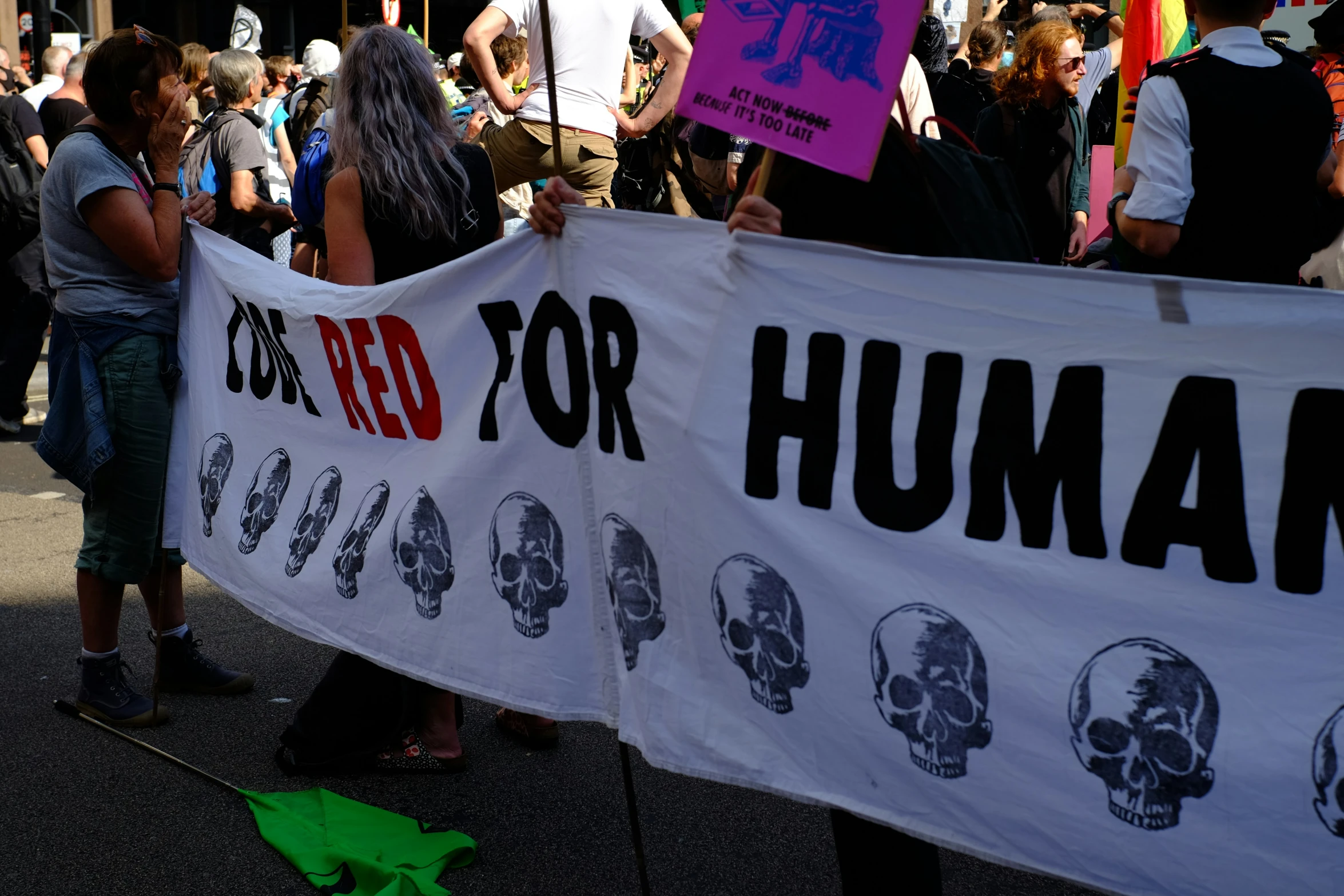 many people hold signs and walk in a parade