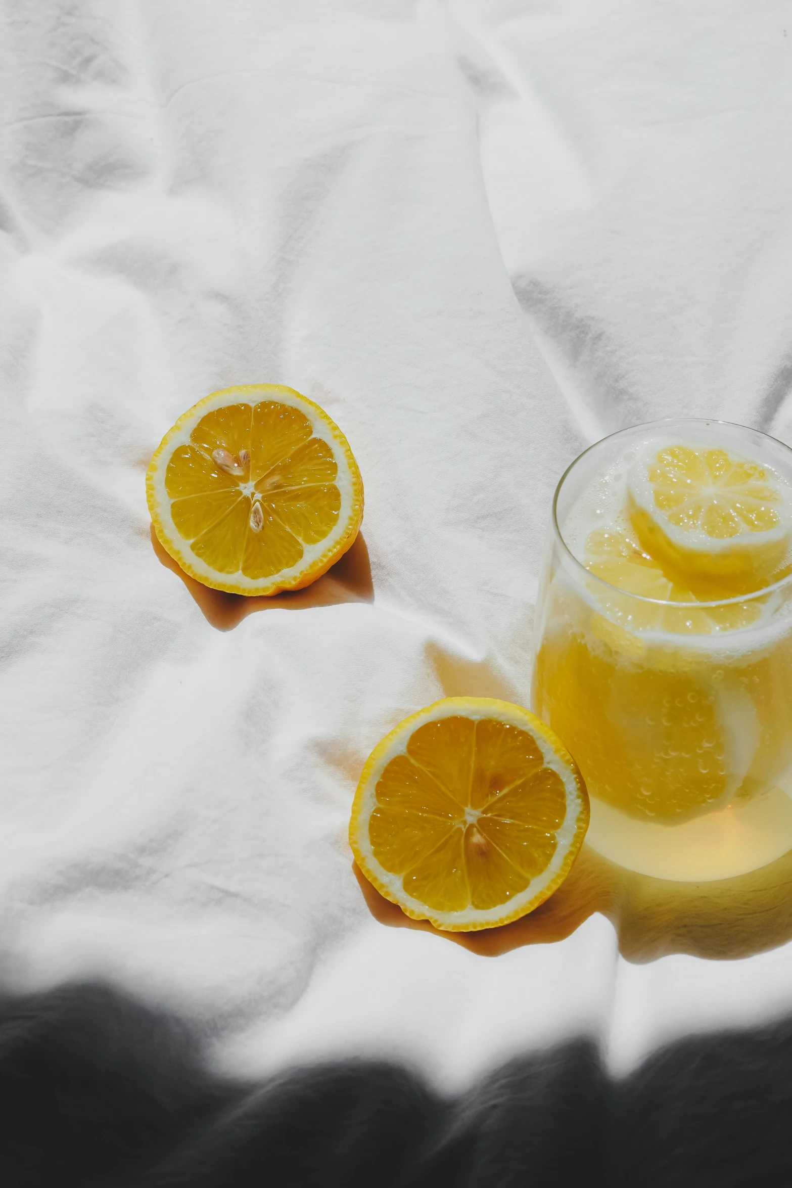 lemon slices are arranged next to a pitcher and some white napkins