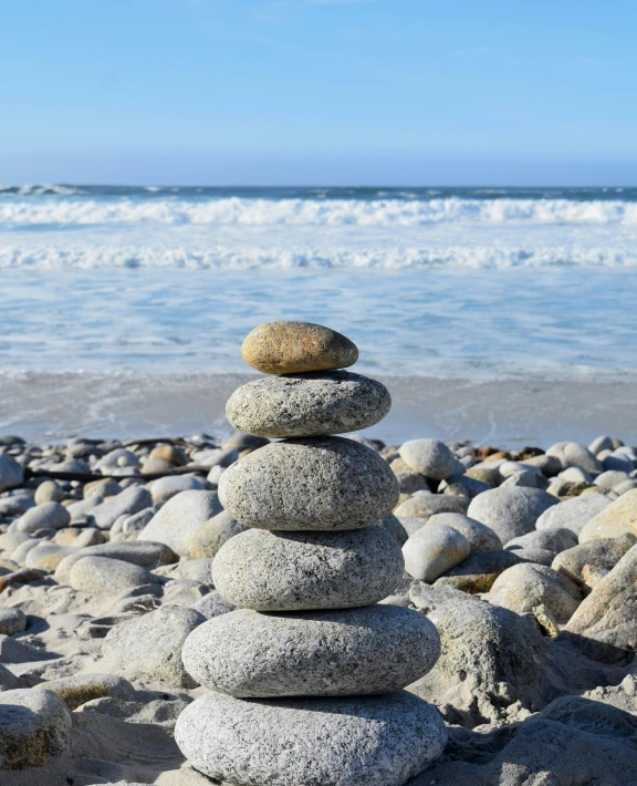 a pile of rocks sitting on top of a beach