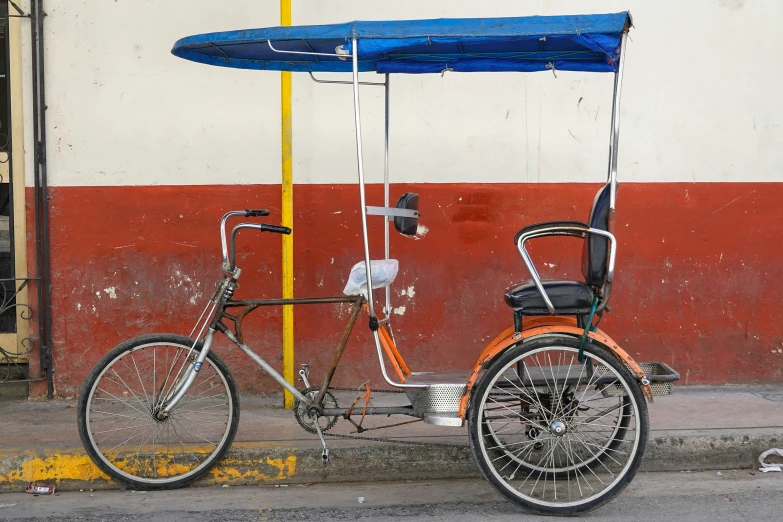 a bike is parked in front of an orange and white building