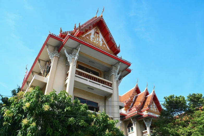 an ornately colored building overlooks the trees