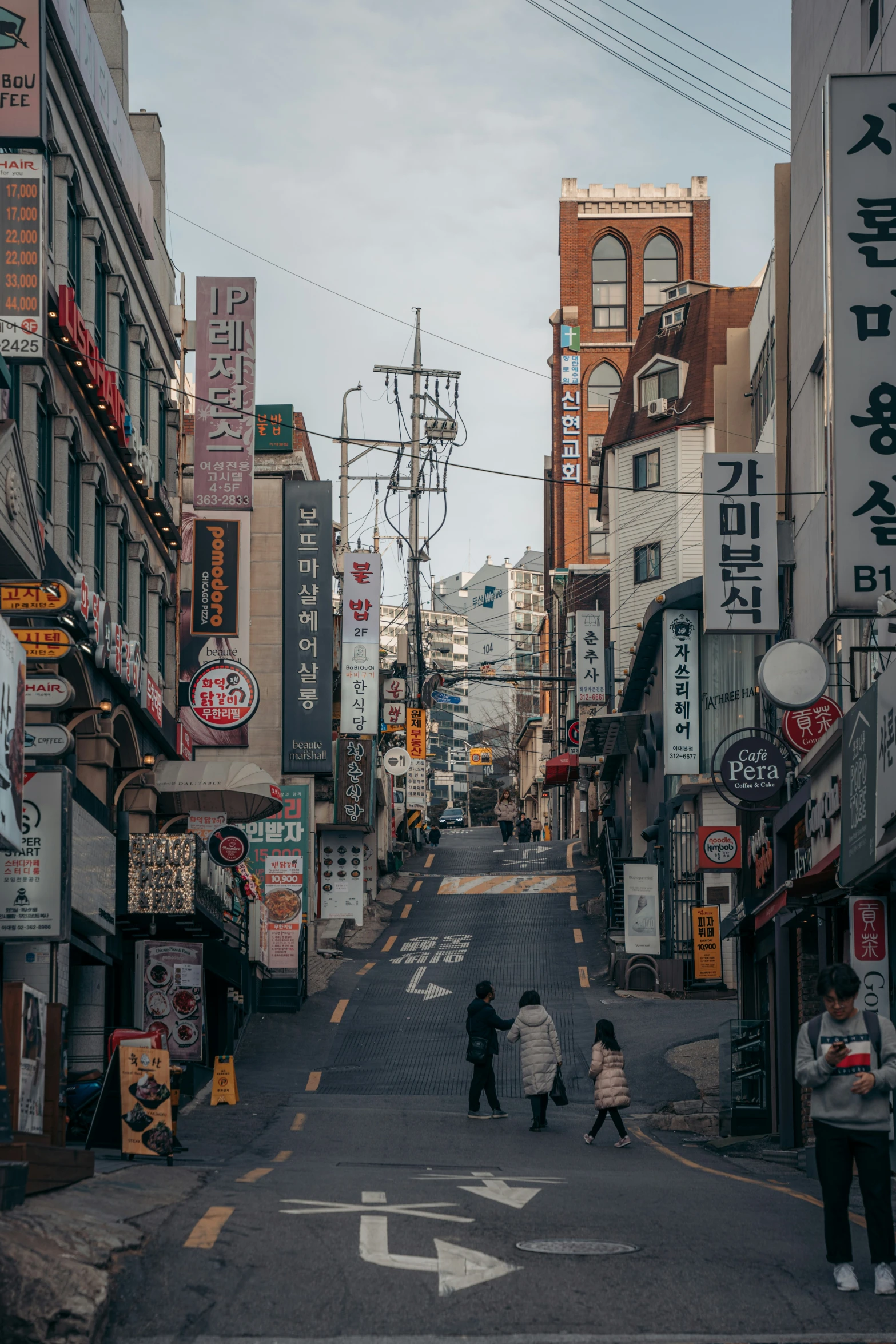 two people crossing the street in the city