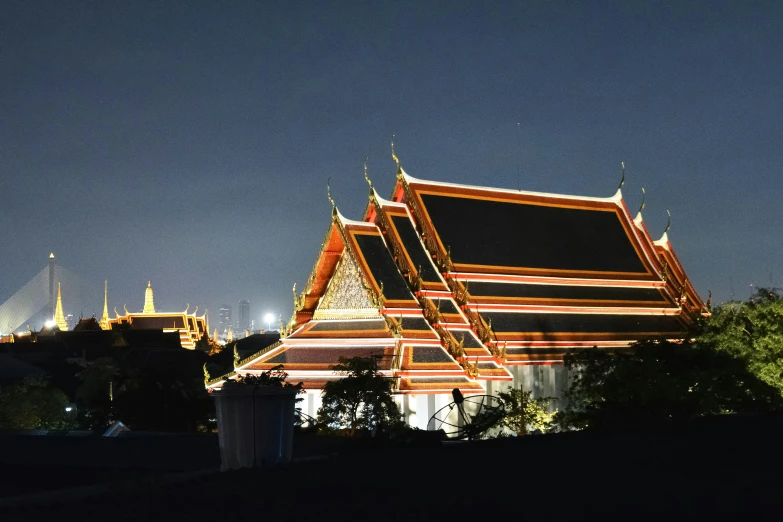 an asian style building lit up at night