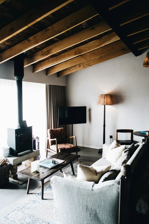 a living room with two couches facing towards a television and a fireplace