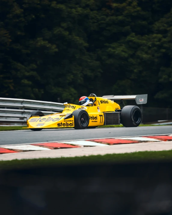 a man driving a racing car around a track