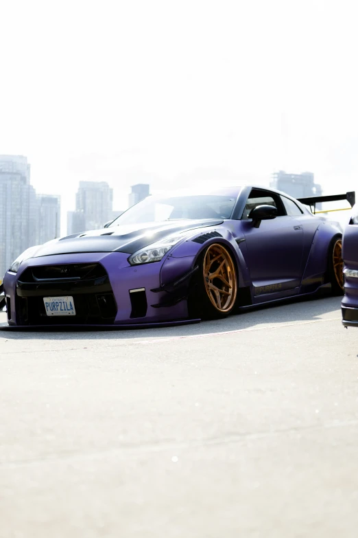 purple sports car with gold wheels and wheels