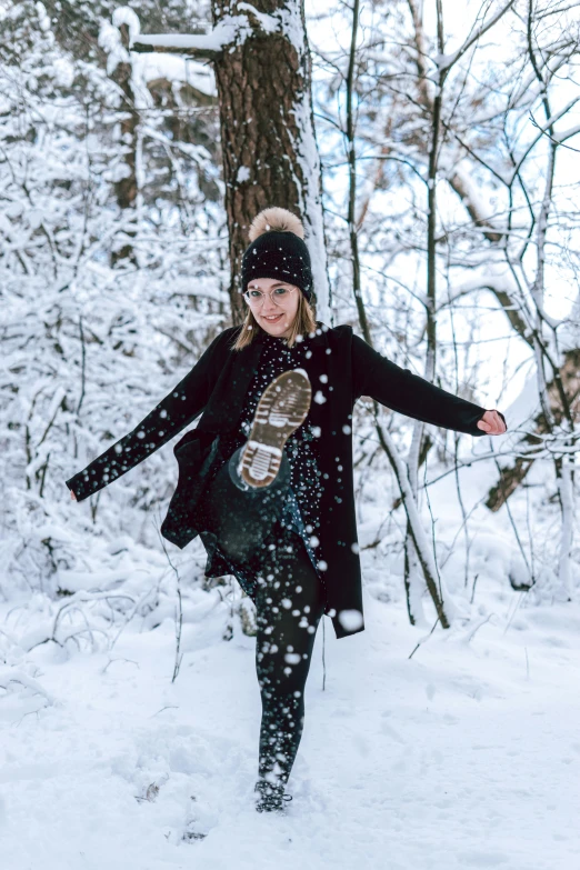 a person standing in the snow with a snowboard