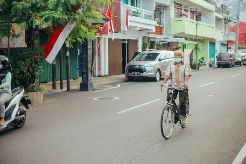 a man on a bike in the middle of a street