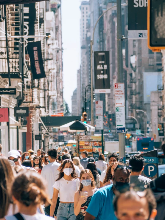 a crowded city street with traffic and pedestrians