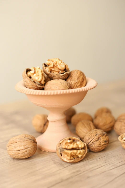 a bowl of nuts next to some smaller ones on the table