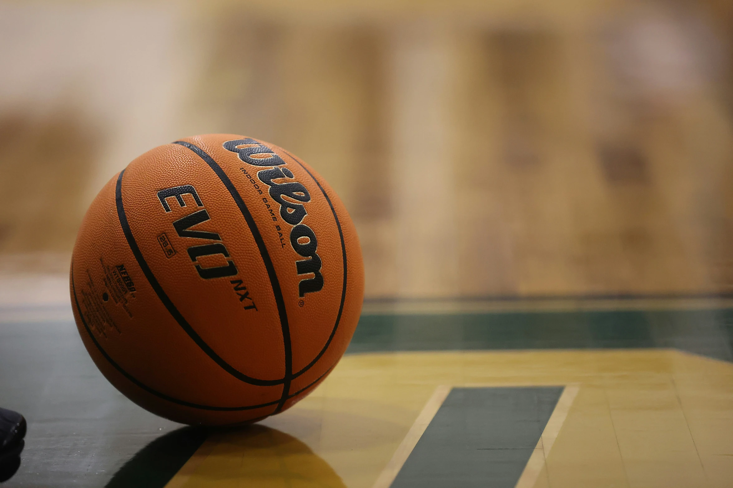 the basketball has been placed on top of a basketball floor