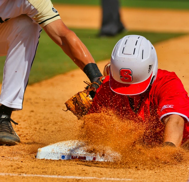 the catcher tries to avoid the throw at first base