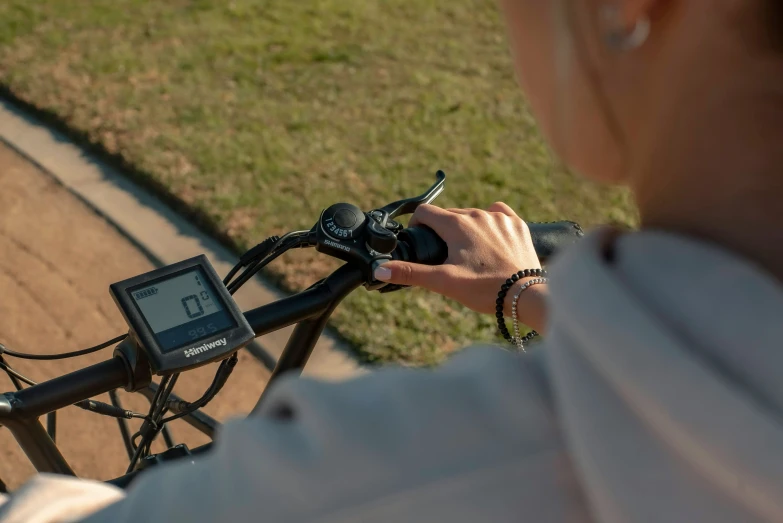 a man holding a camera in his hand next to a bike