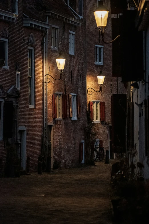 a building with a light on and windows lit up