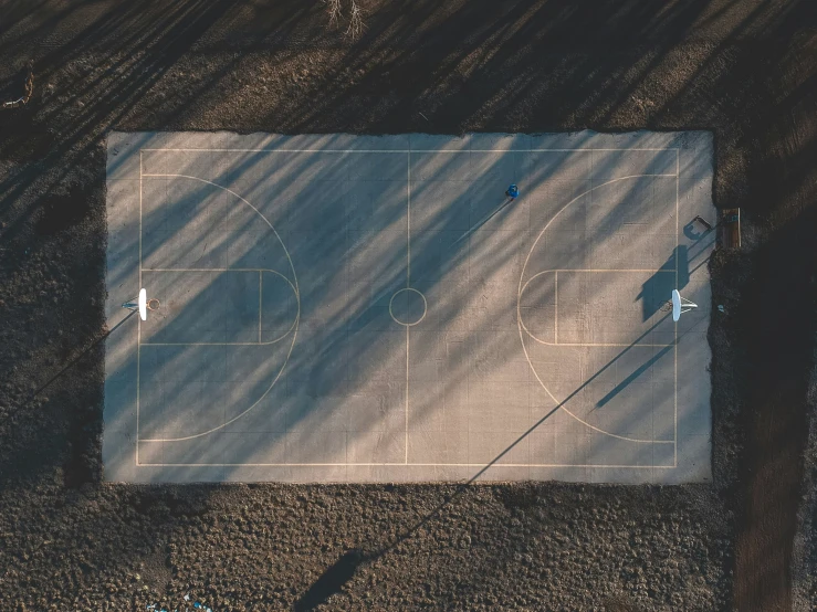 an overhead view of a basketball court from a distance