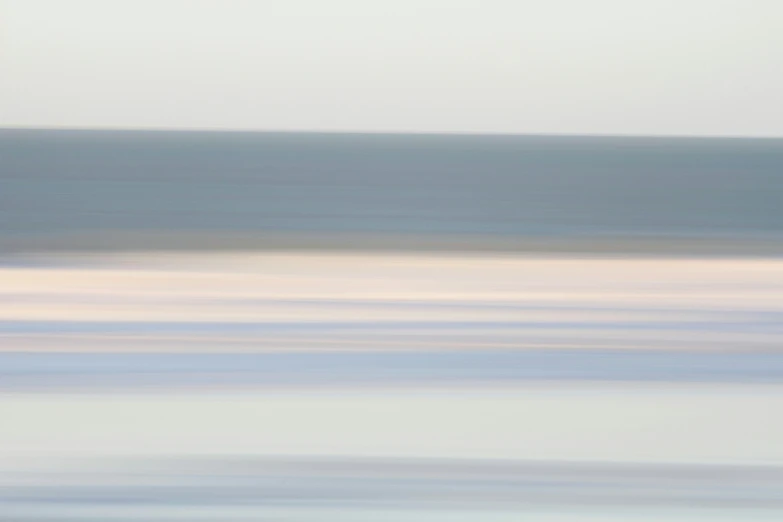 an abstract po of two surfers in front of the ocean