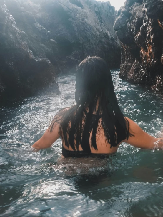 a woman with long hair is in the water