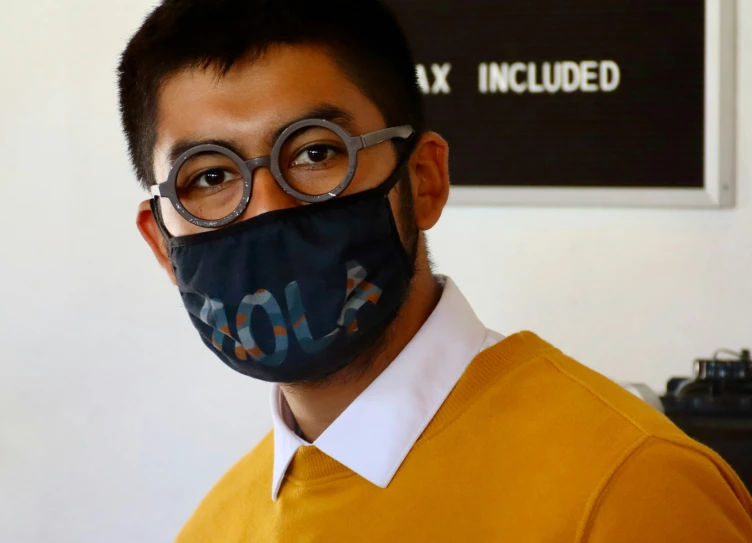 a man wearing glasses and a mask with the word war printed on it