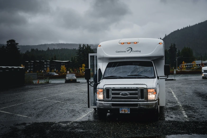 a small food truck sits in a parking lot