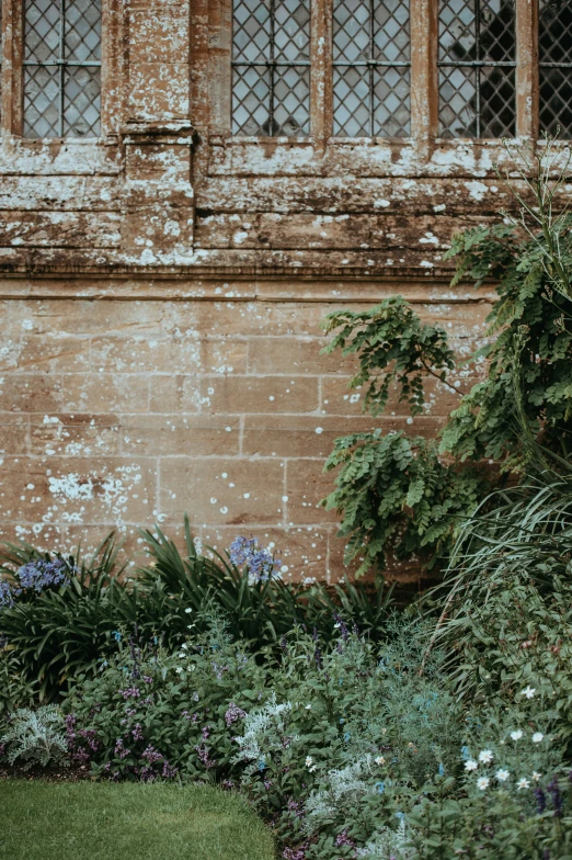 there is an old stone wall that has been converted into a garden area