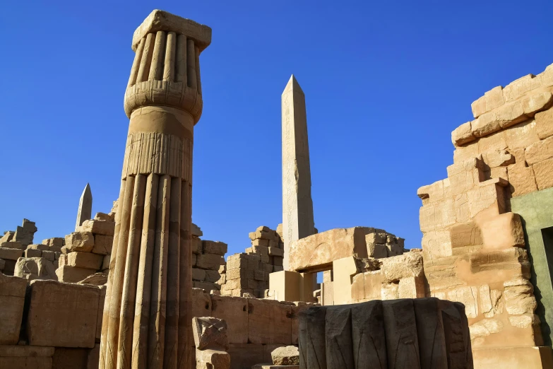 ancient ruins with large stone column in front